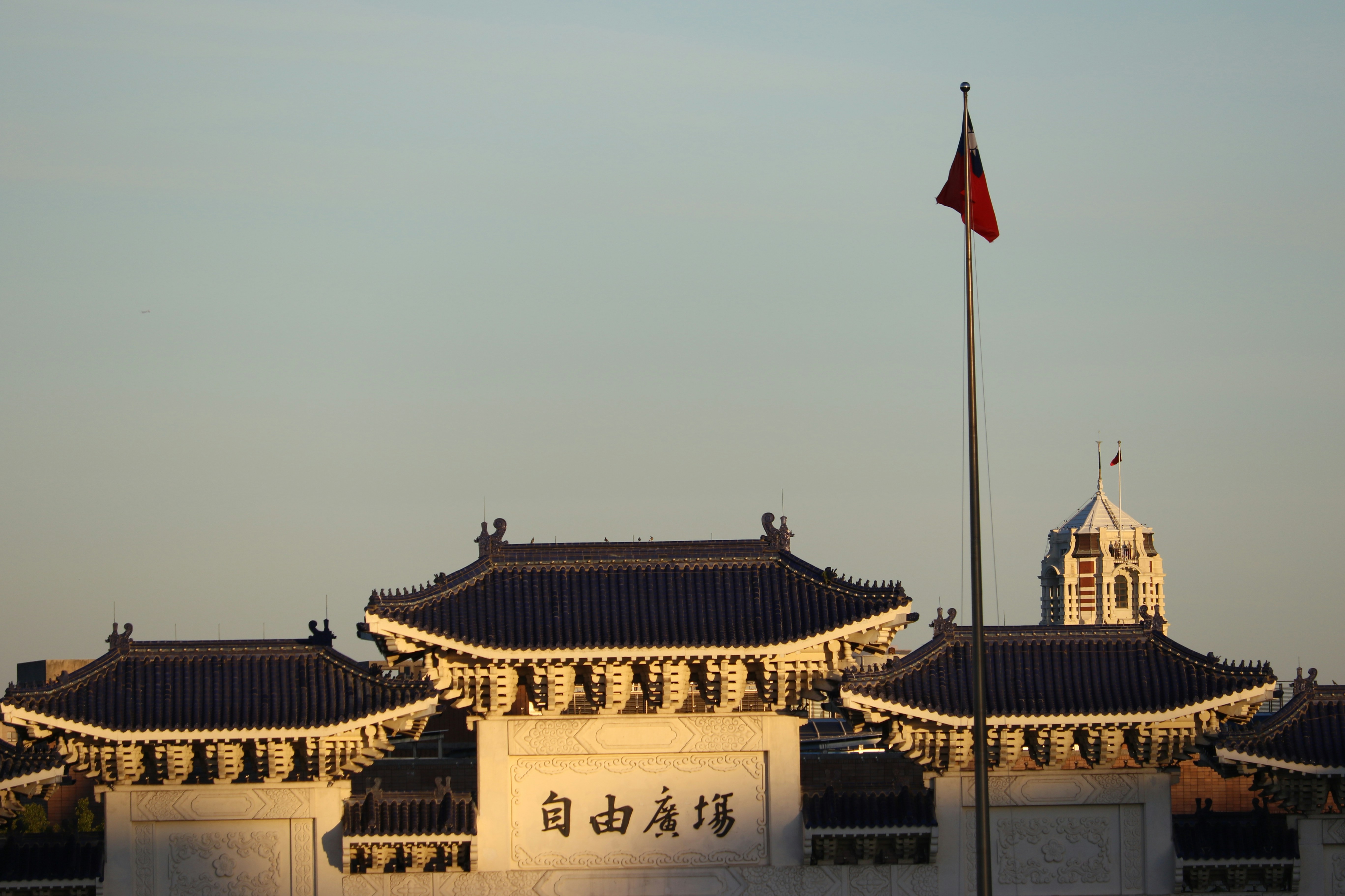 Traditional building with a flag at sunset
