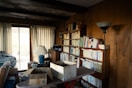 Living room with bookshelves and boxes.