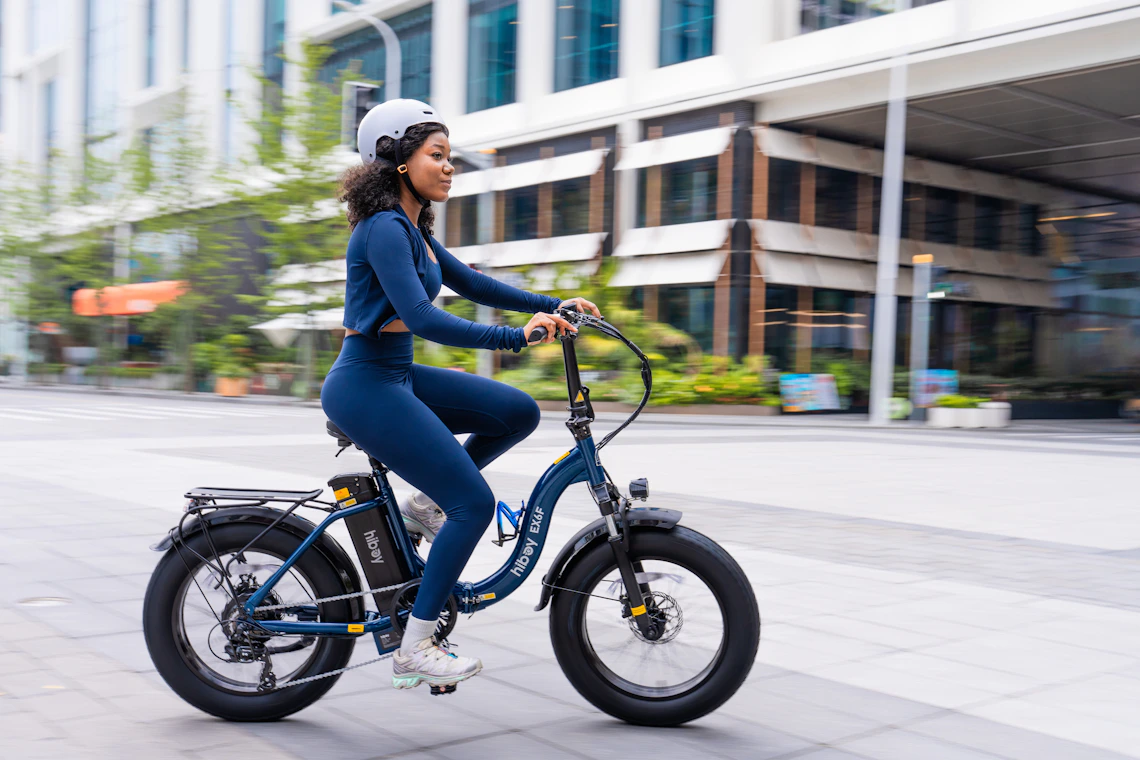 Helmeted rider on an electric bicycle in an urban environment