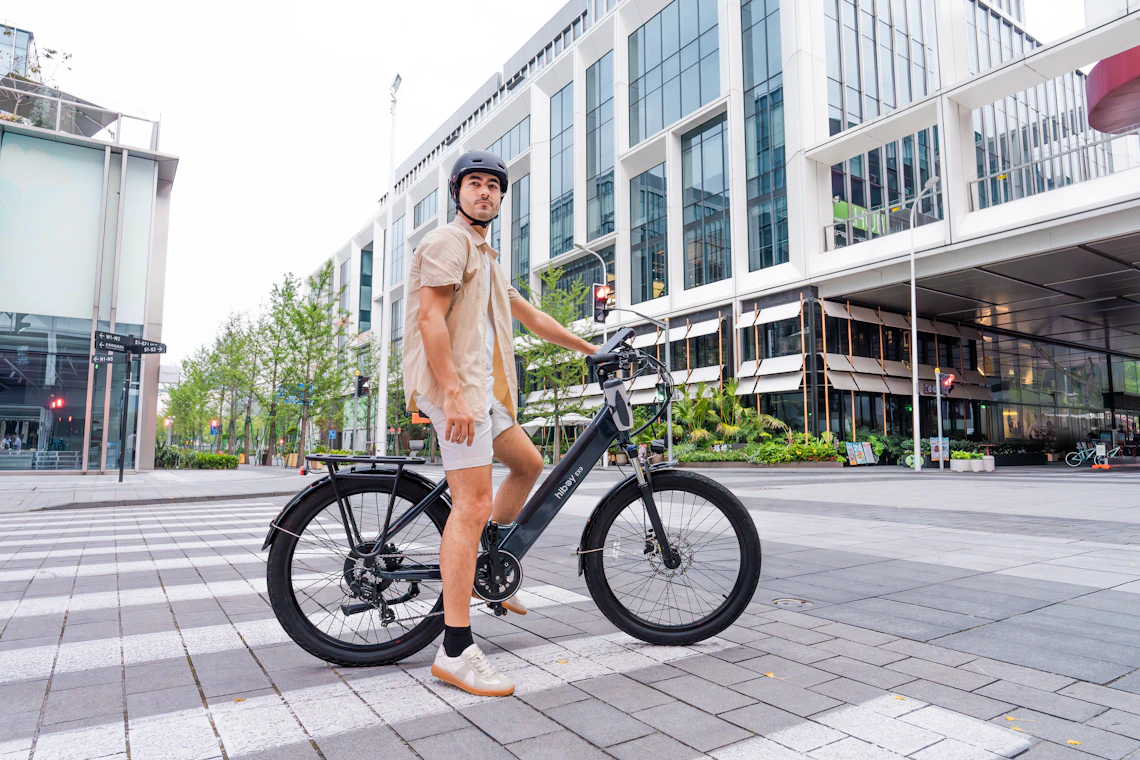 Urban cyclist with an electric bicycle in a modern city
