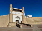 Ancient fortress gate with towers under a blue sky