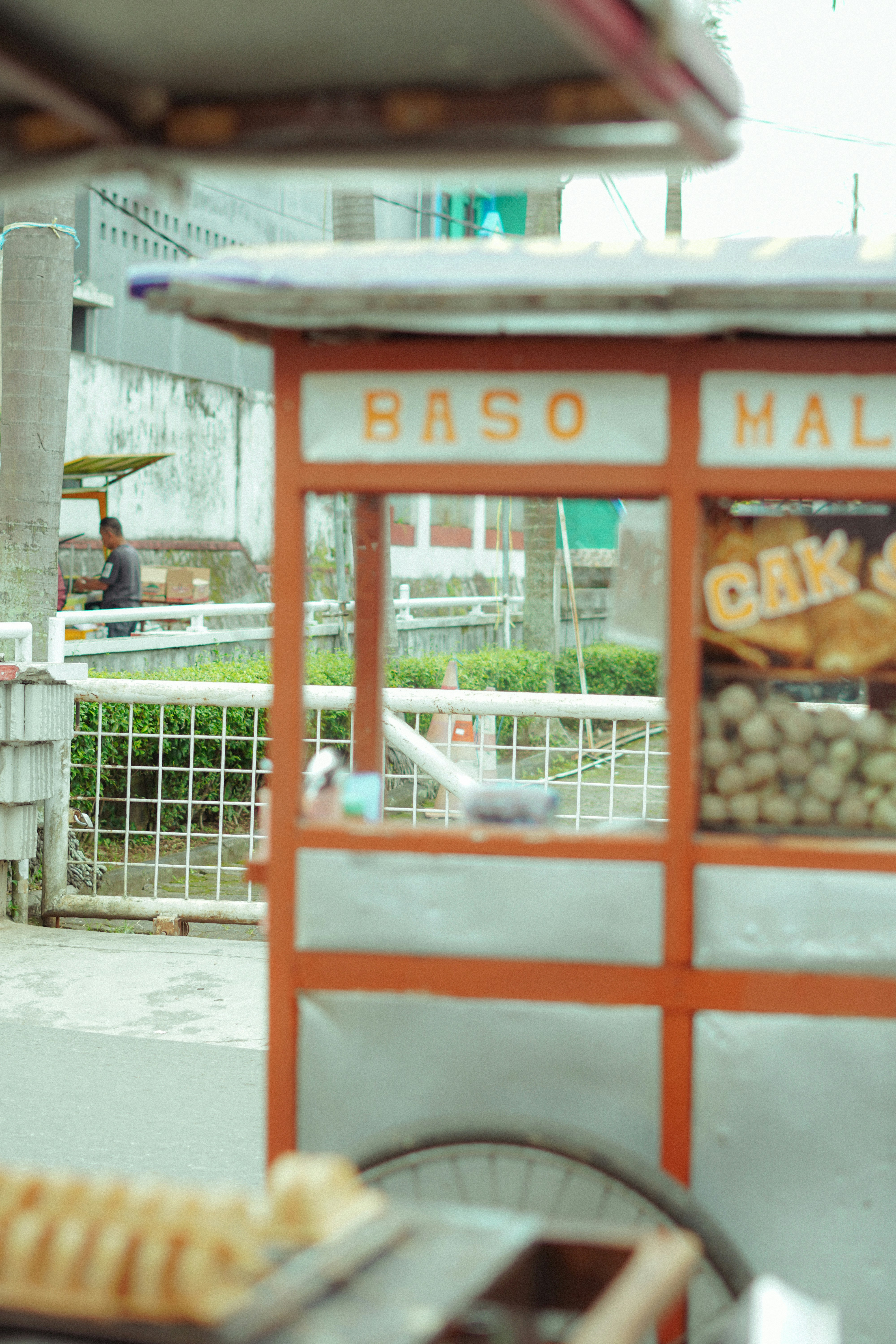 Orange food cart with 'baso malang' sign