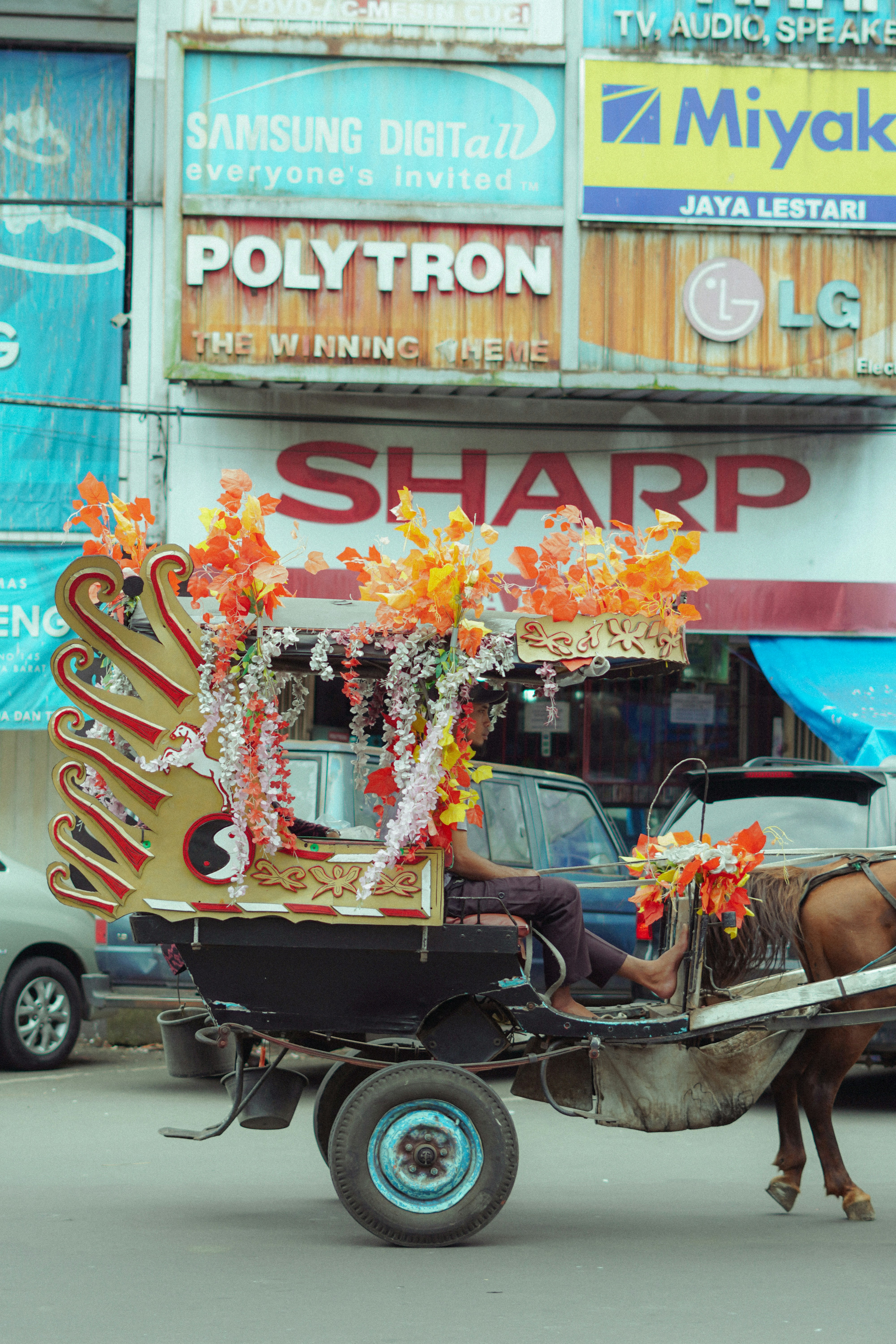 Horse-drawn carriage decorated with colorful flowers.