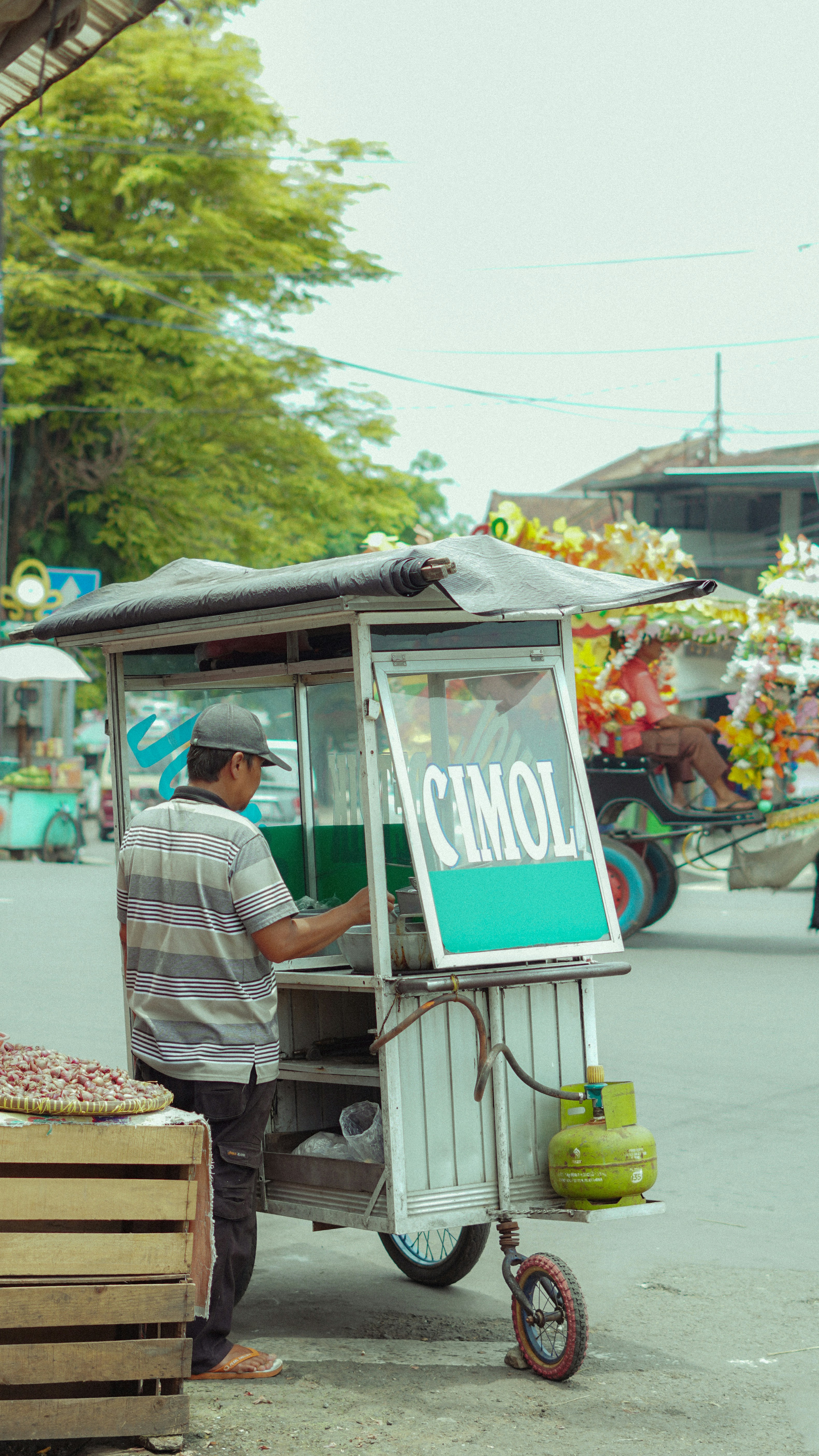 Man serving food from a street cart.