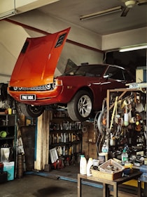 Orange classic car being repaired in garage