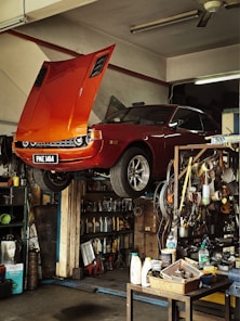 Orange classic car being repaired in garage