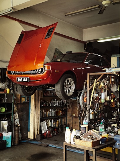Orange classic car being repaired in garage