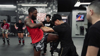 Two men sparring during a muay thai training session.
