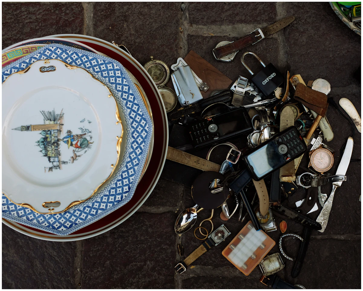 Stacks of decorative antique plates and assorted vintage objects