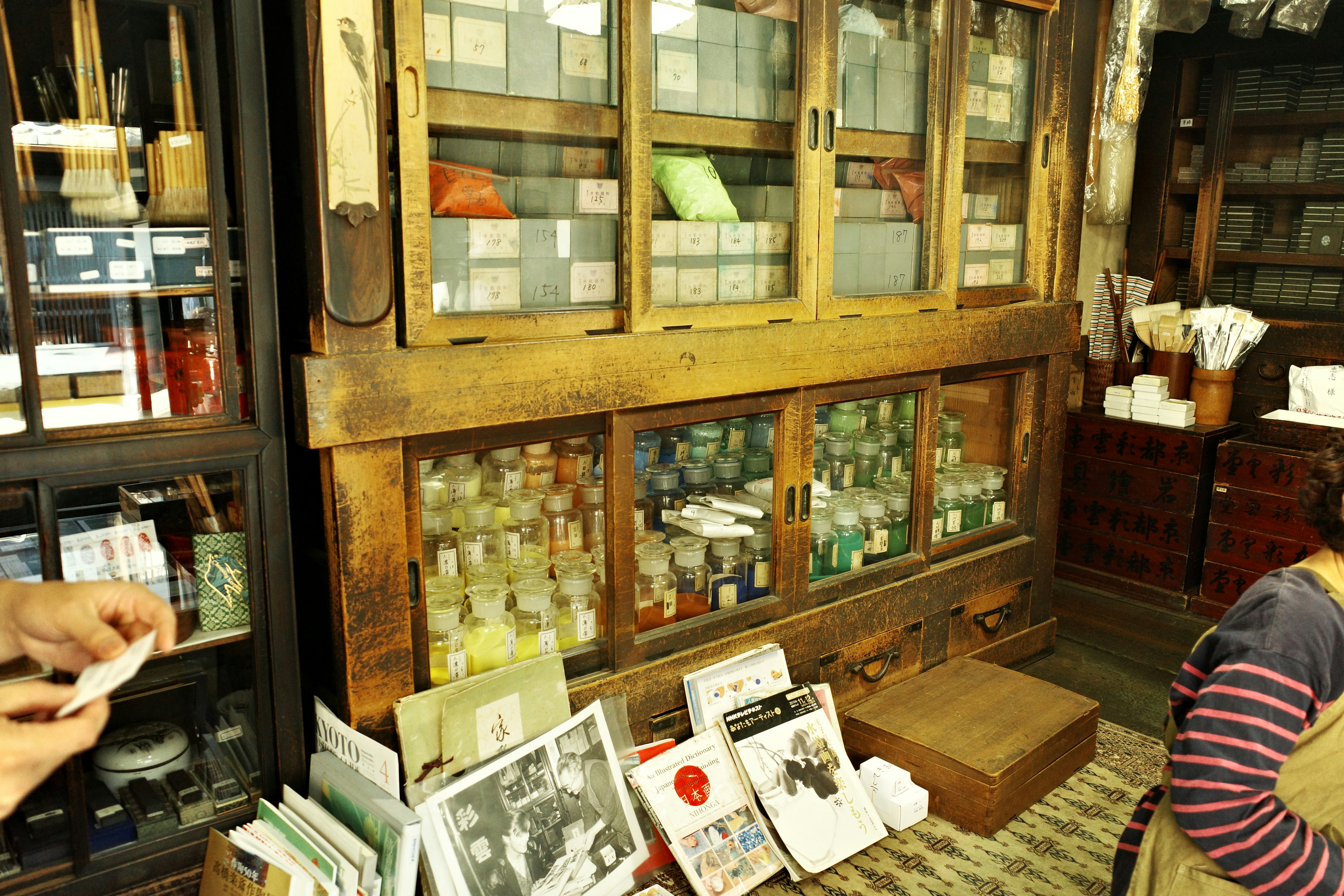 Antique shop with glass display cabinets of bottles.