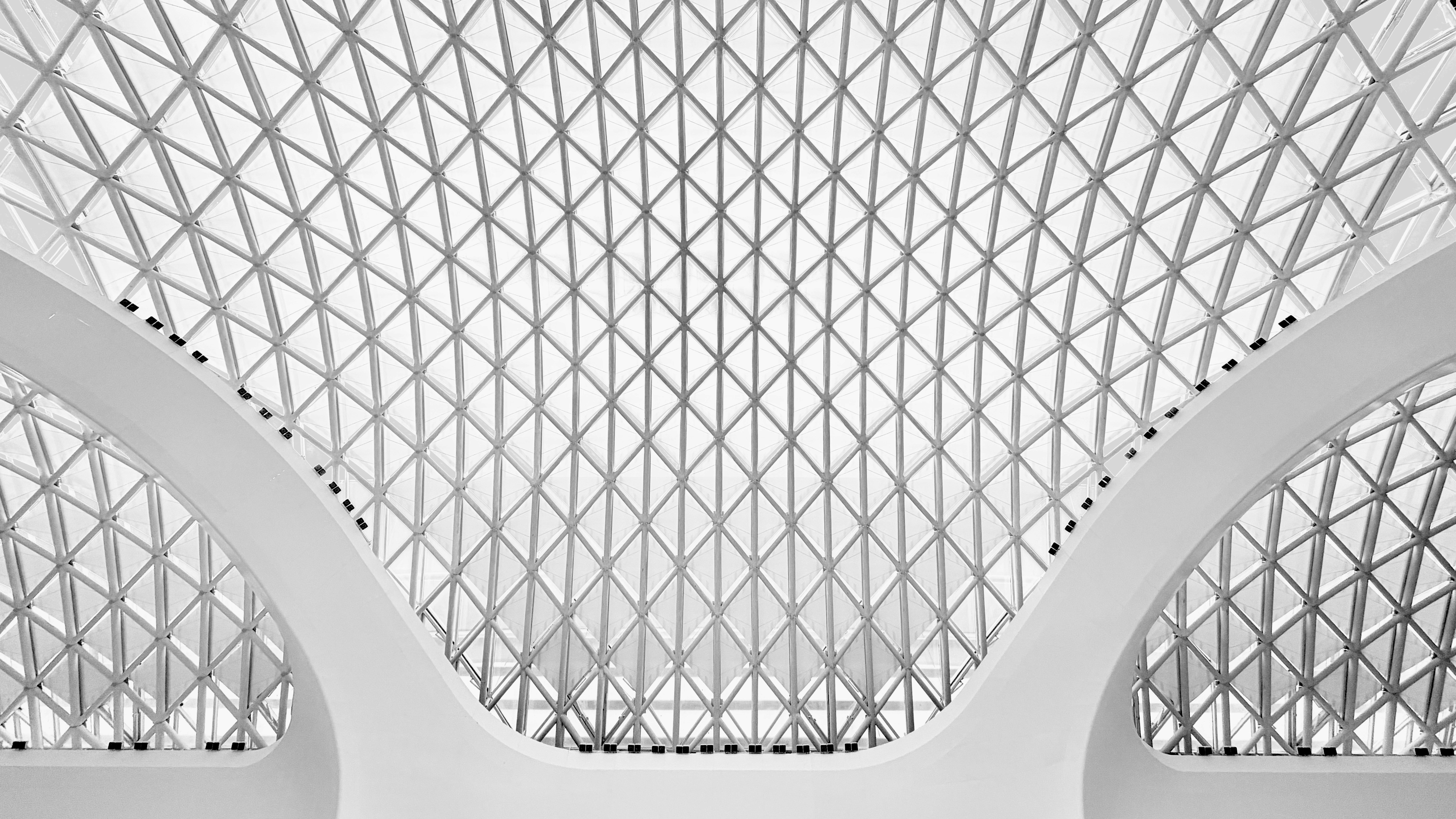 Moderne geometrische Deckenstruktur mit weißen Bögen