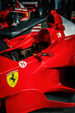 Red ferrari race car with horse emblem.