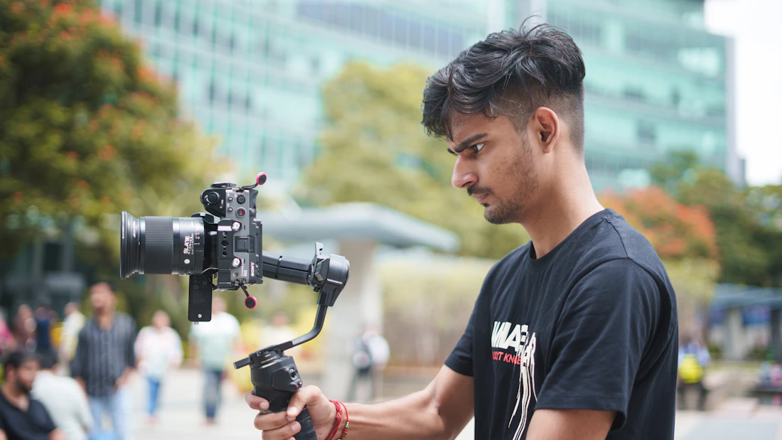 Videographer operating a camera on a gimbal during a shoot