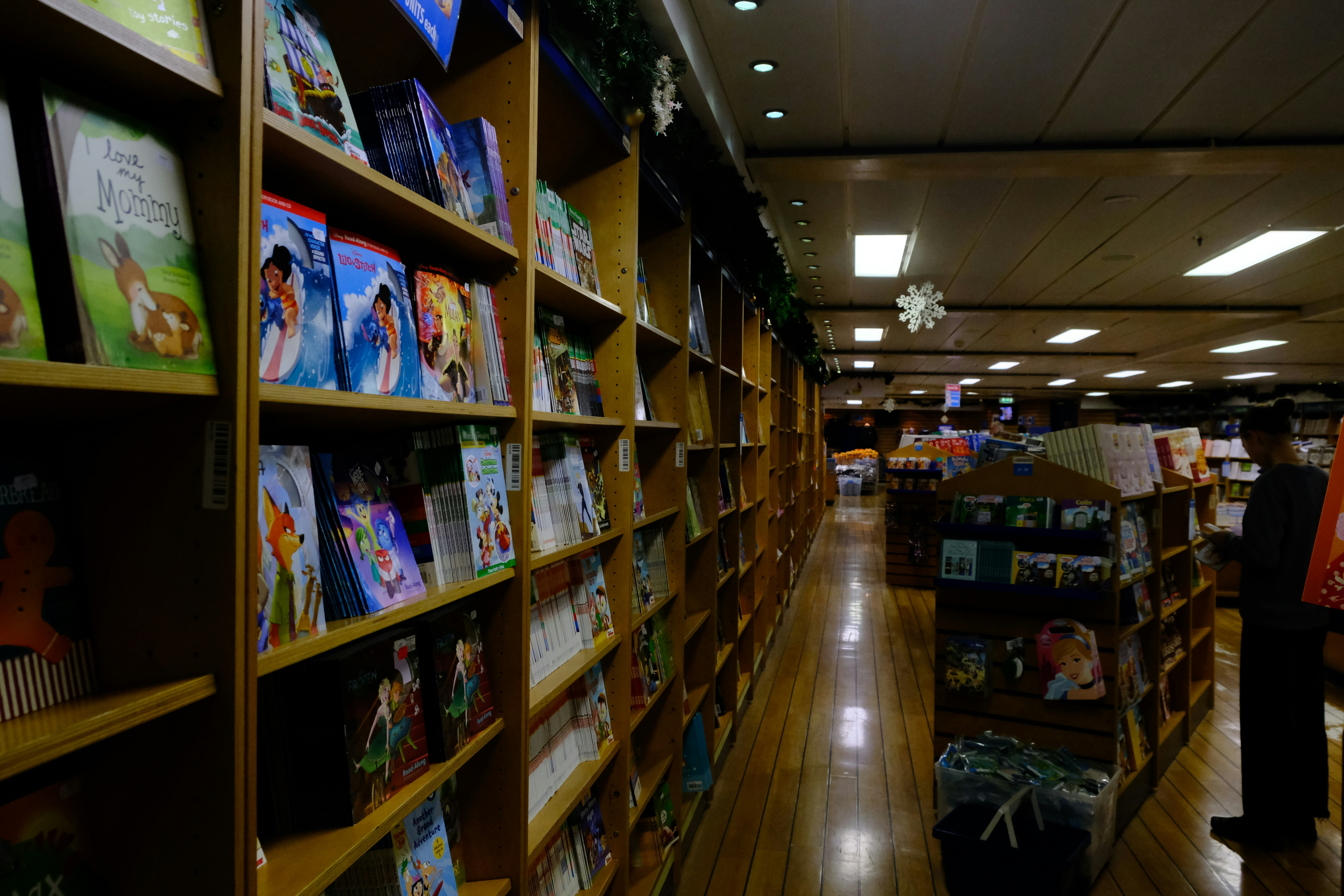 A bookstore aisle filled with books on shelves.