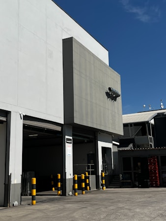 Modern Class A industrial building exterior with a row of loading doors, similar to the planned Southwest Bay project at Russell Road and Edmond Street