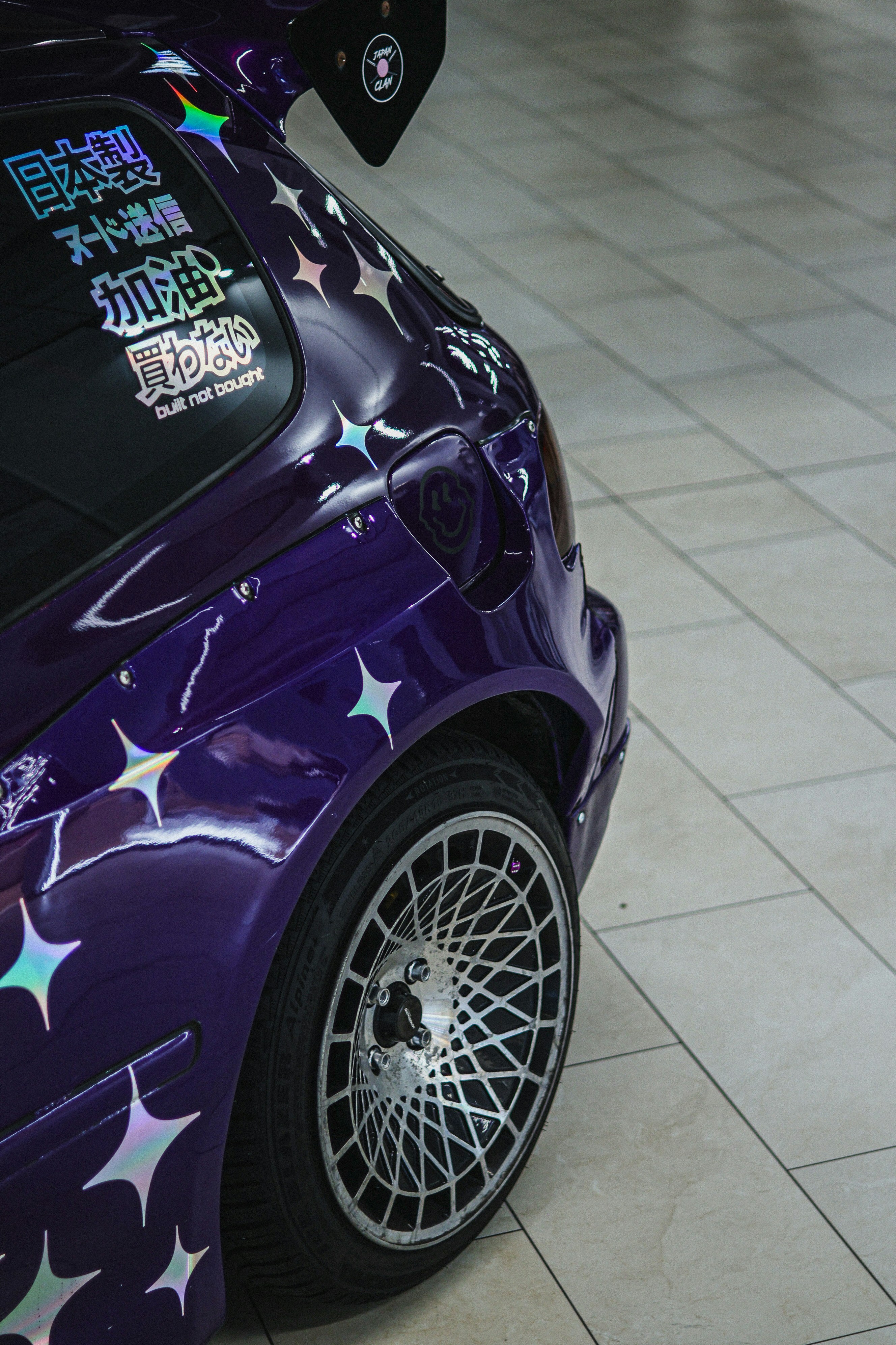 Purple car with star decals and custom wheels