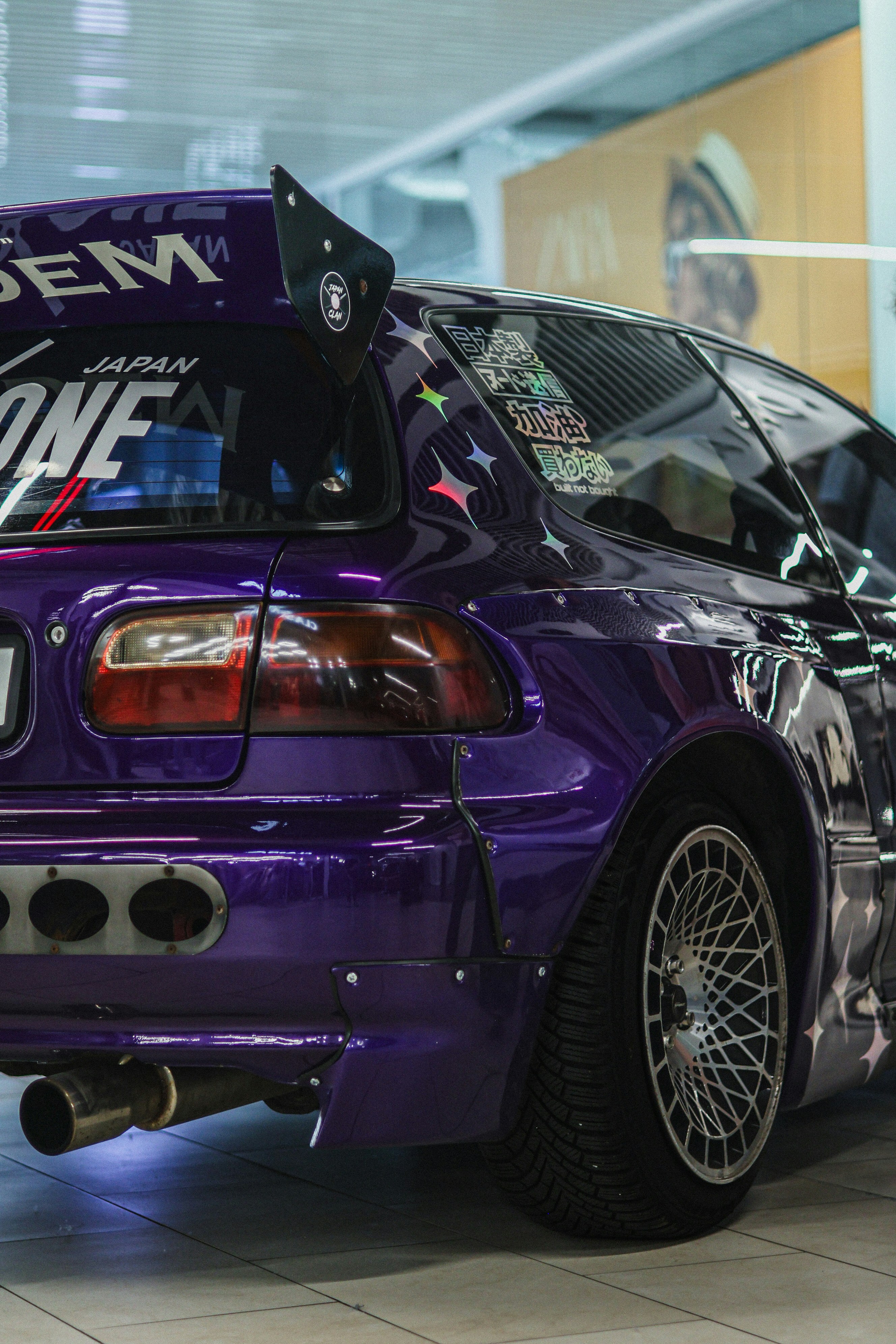 A finished custom car with a vibrant, multi-layered paint job.