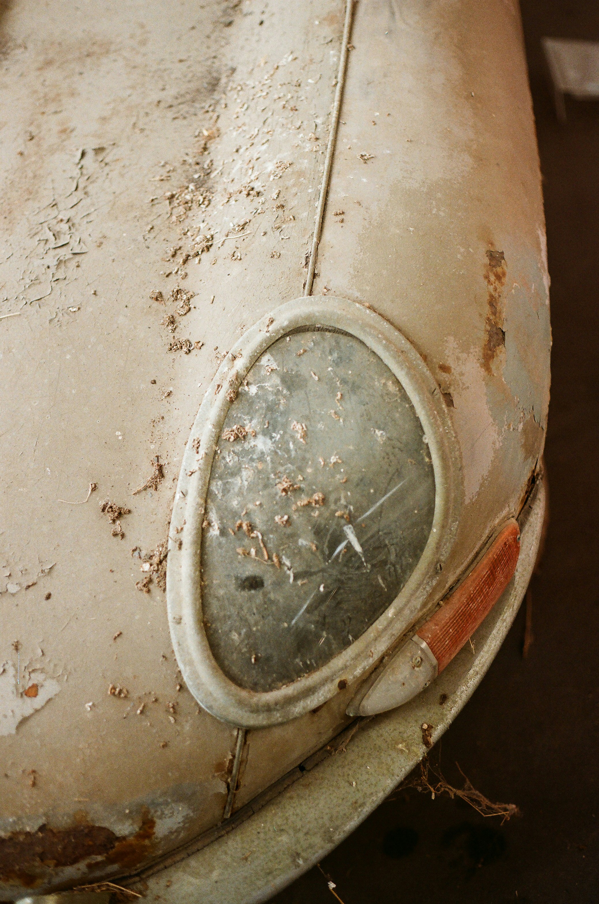Close-up of a dusty, old car headlight