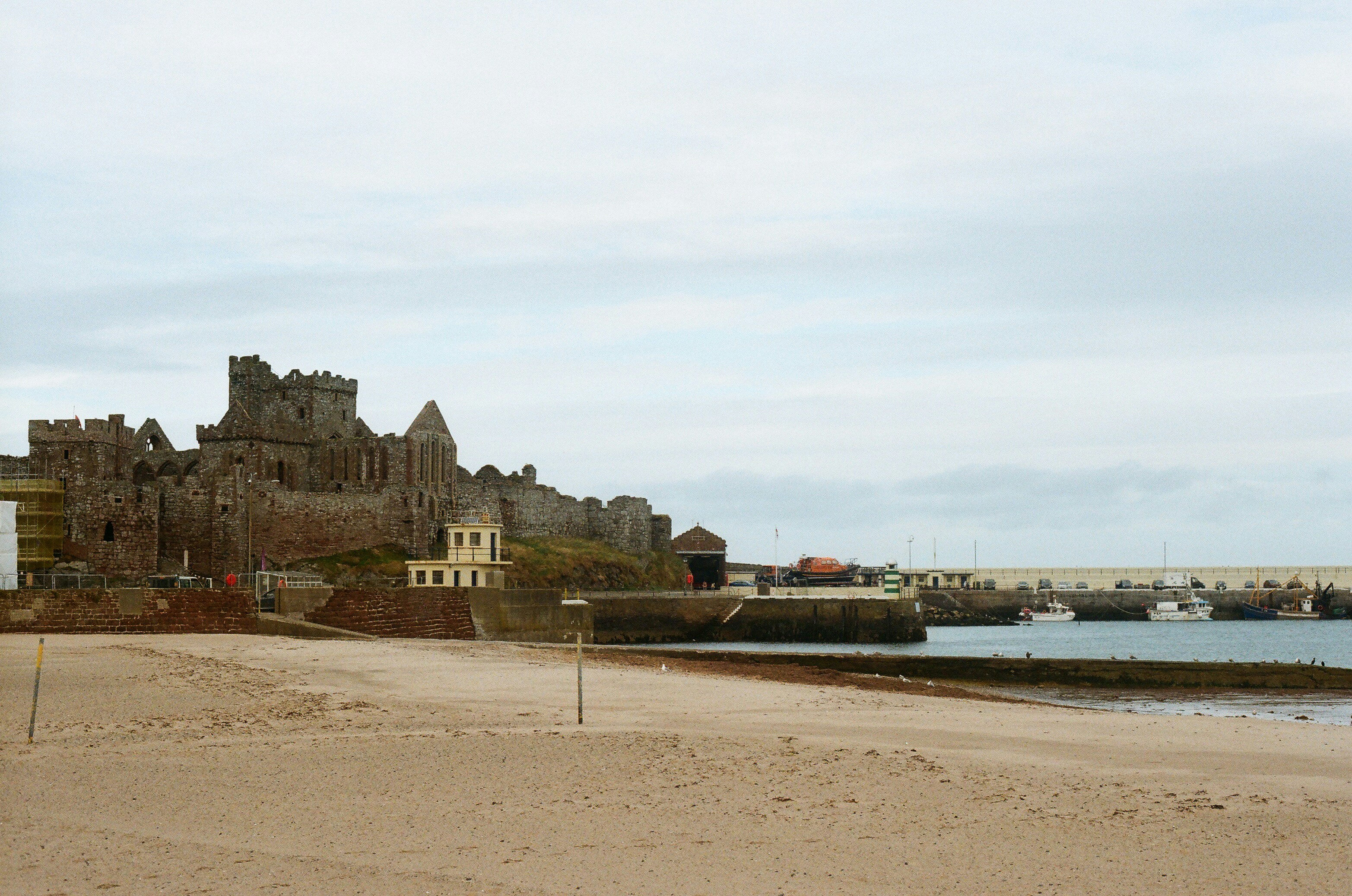 Castle ruins on a hill overlooking a harbor