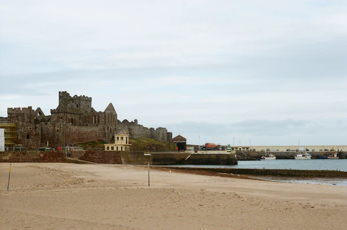 Ruined stone fort on a hill overlooking the harbor, similar to Fort Gustav and Fort Karl