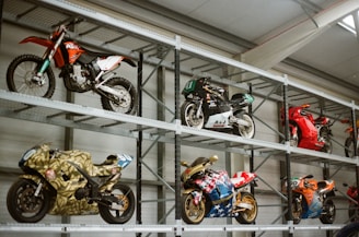 Motorcycles displayed on industrial shelving units.