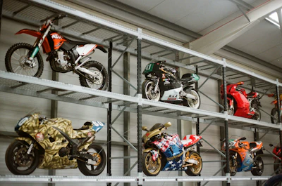 Motorcycles displayed on industrial shelving units.