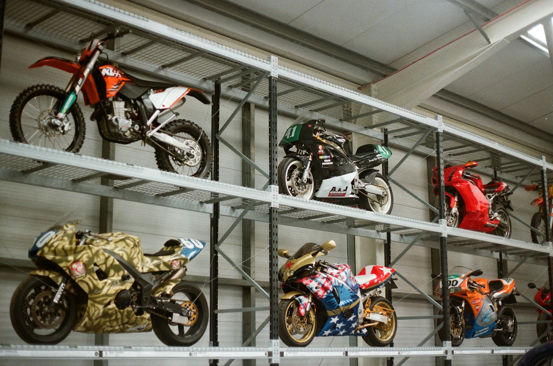 Motorcycles displayed on industrial shelving units.