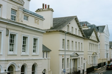 Row of cream-colored buildings under a cloudy sky