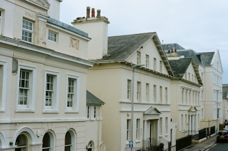 Row of cream-colored buildings under a cloudy sky