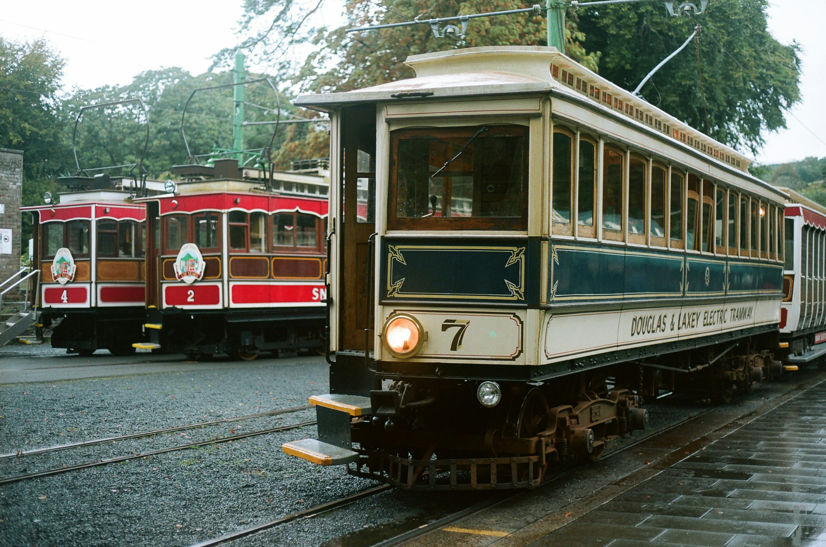 Two vintage electric trams on tracks