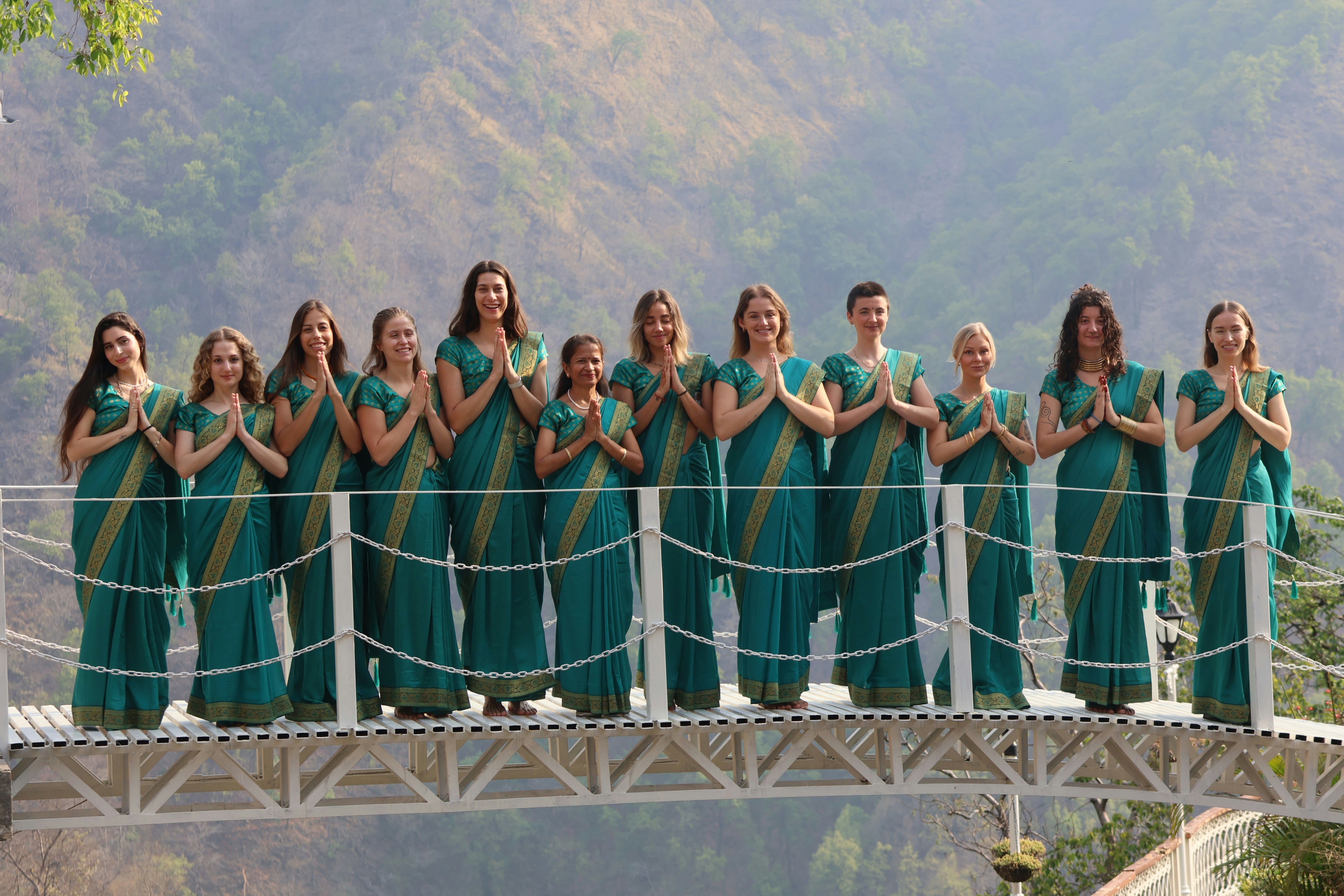 Group of women in saris on a bridge