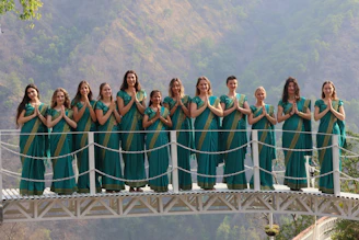Group of women in saris on a bridge
