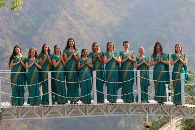 Group of women in saris on a bridge