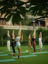 Women practising yoga outdoors