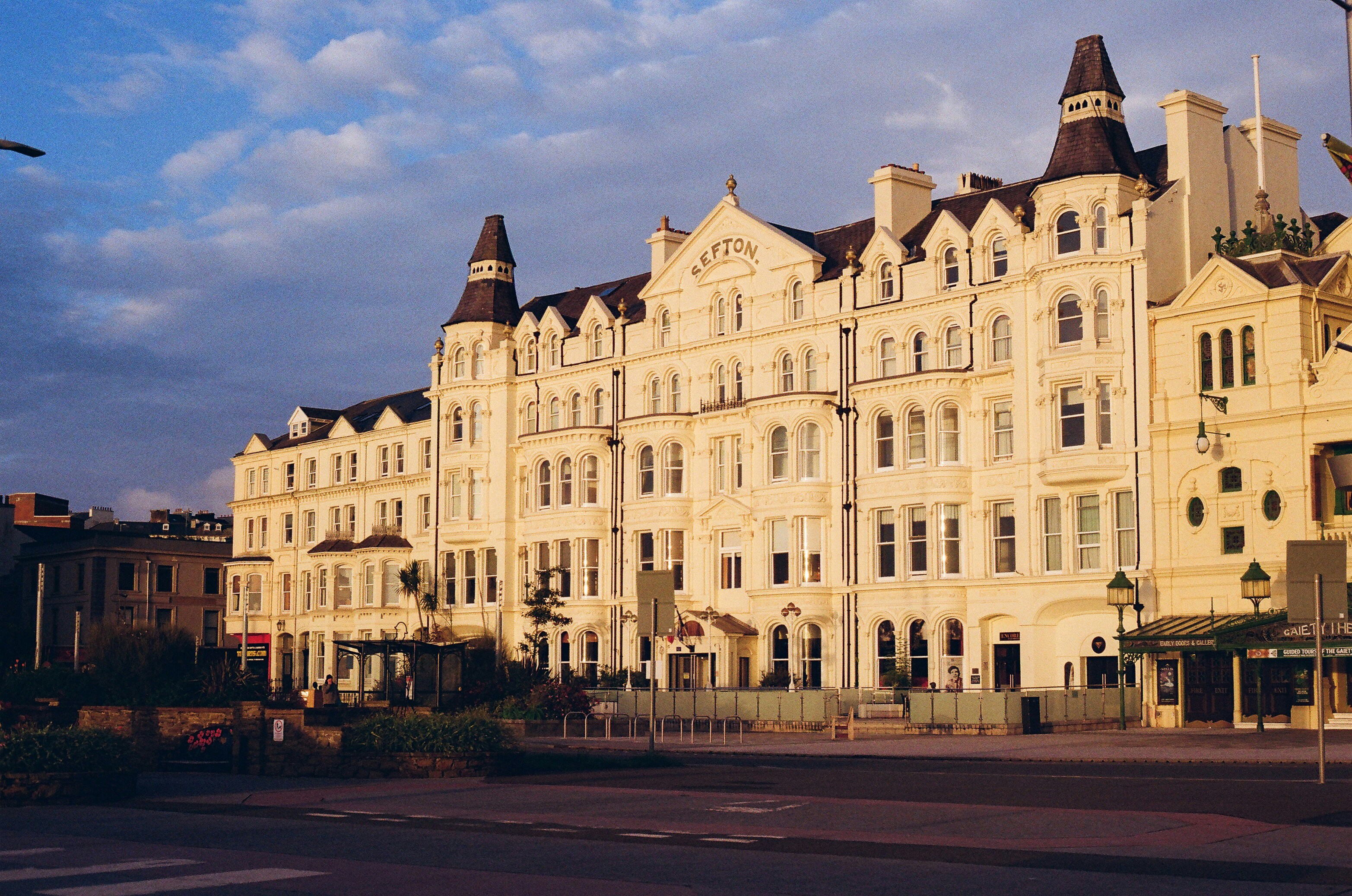 Grand white building with turrets at sunset