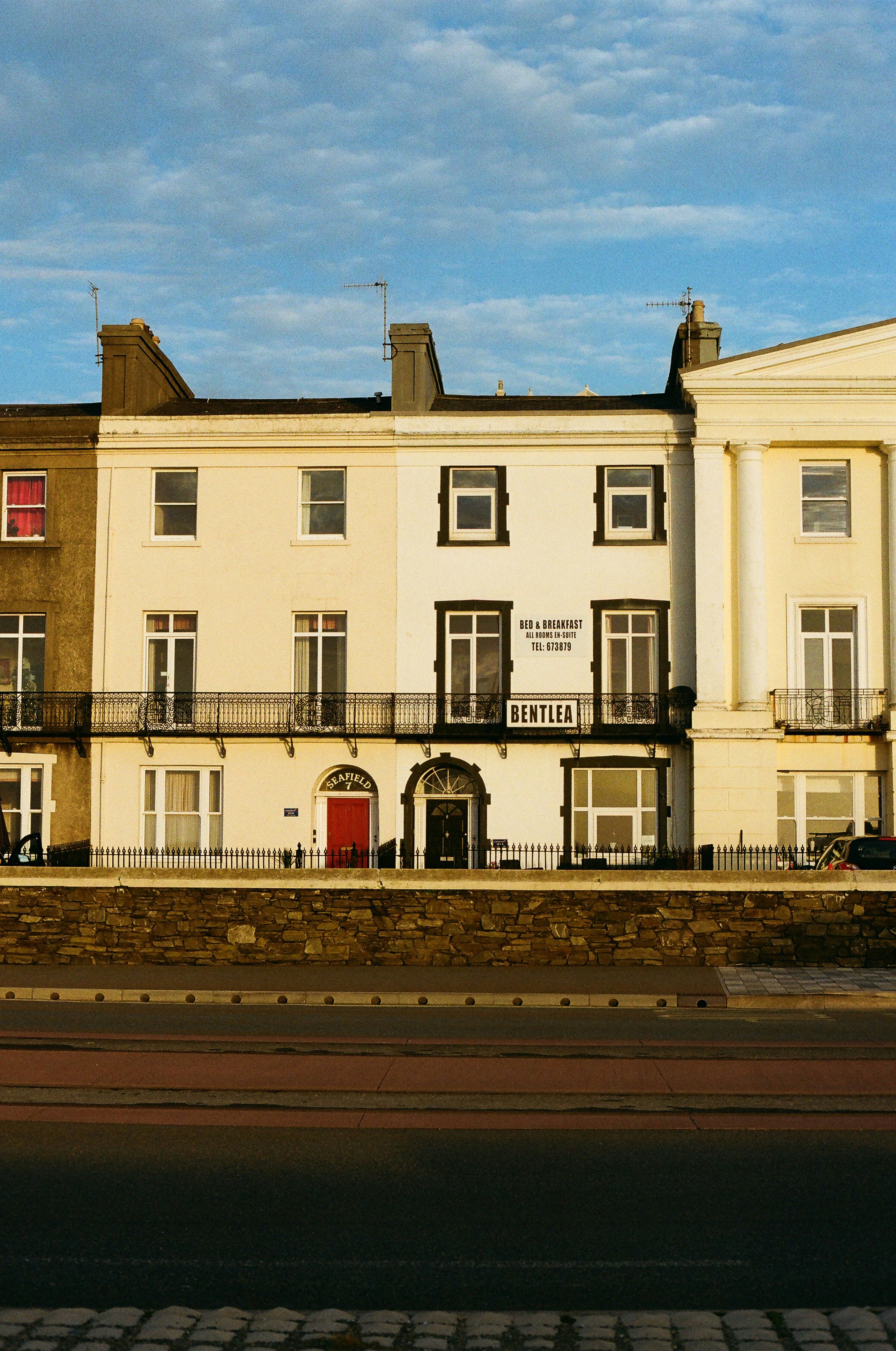 Row of terraced houses with a red door.