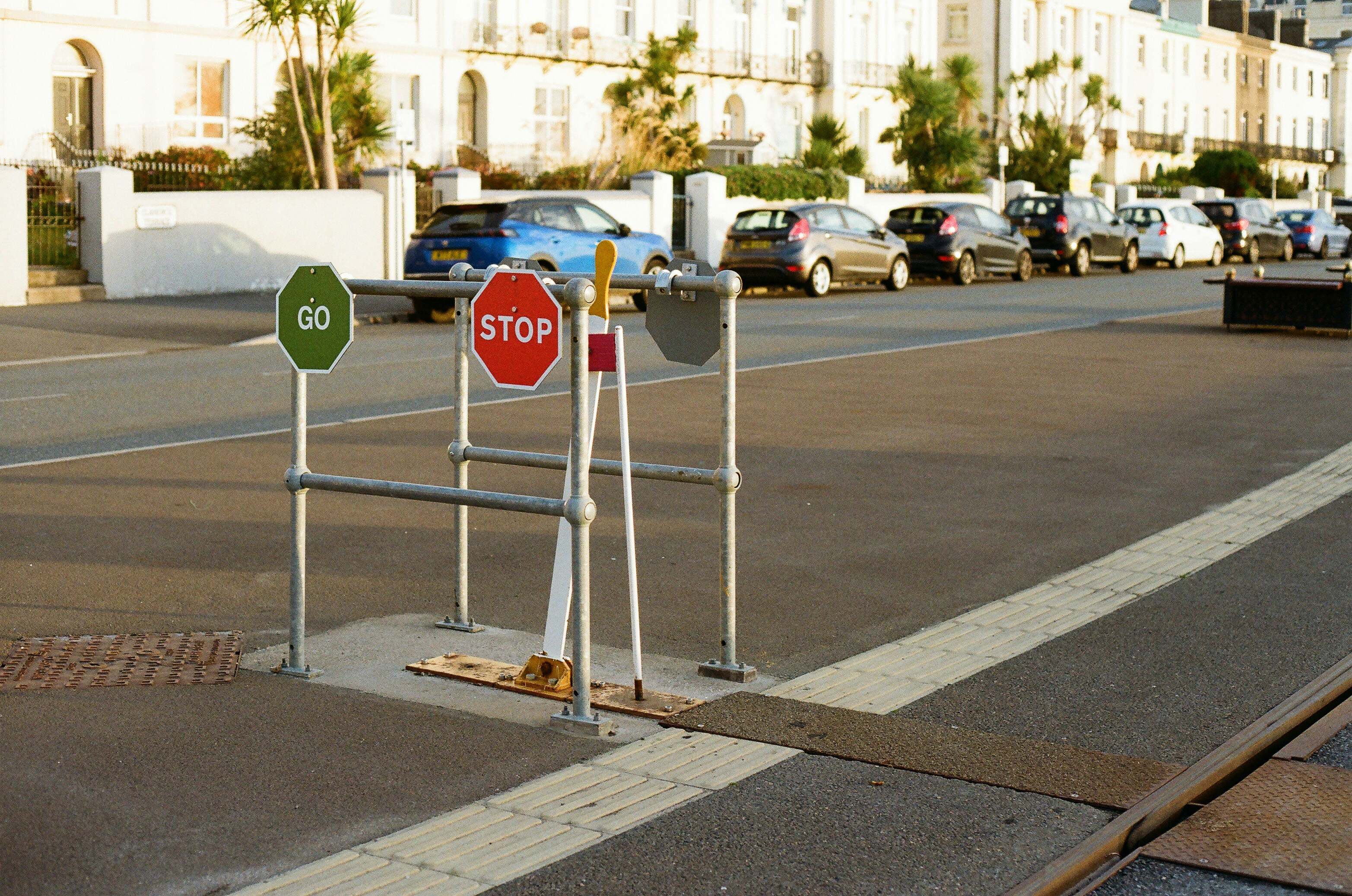 Stop and go signs at a pedestrian crossing.