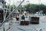 Workers setting up scaffolding in a city street