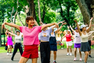 Group of women exercising together in a park.