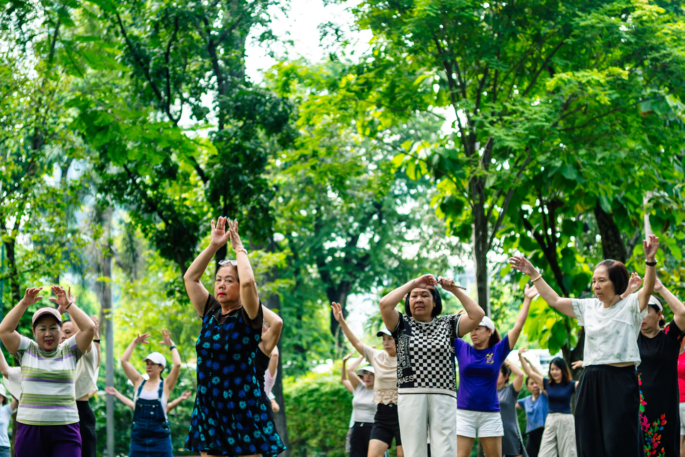 Adults exercising together outdoors in a park