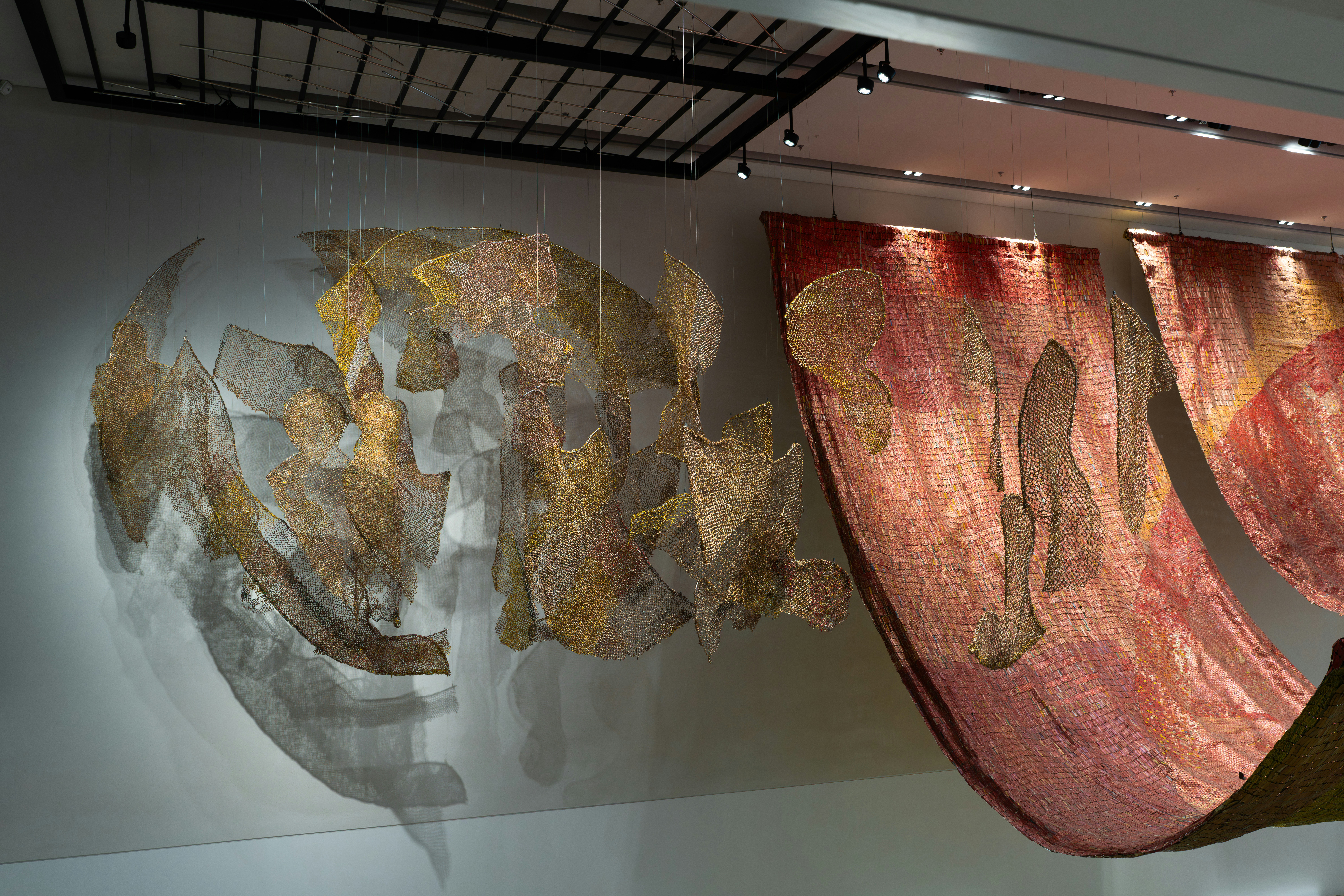 Abstract fabric art hanging in a gallery