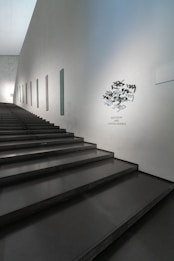 Modern staircase with minimalist art on wall
