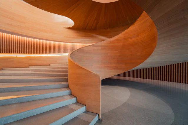 Modern spiral staircase with wooden accents and lighting