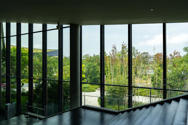 Floor-to-ceiling windows with a clear view of green trees