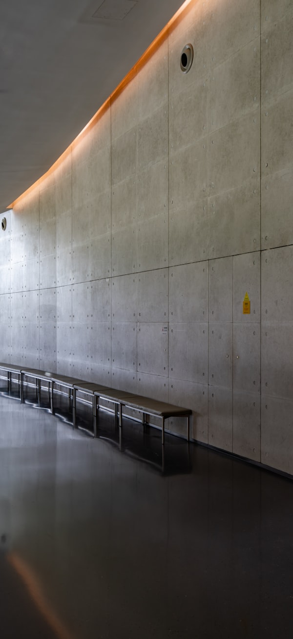Warm lighting along a concrete wall — light as intention