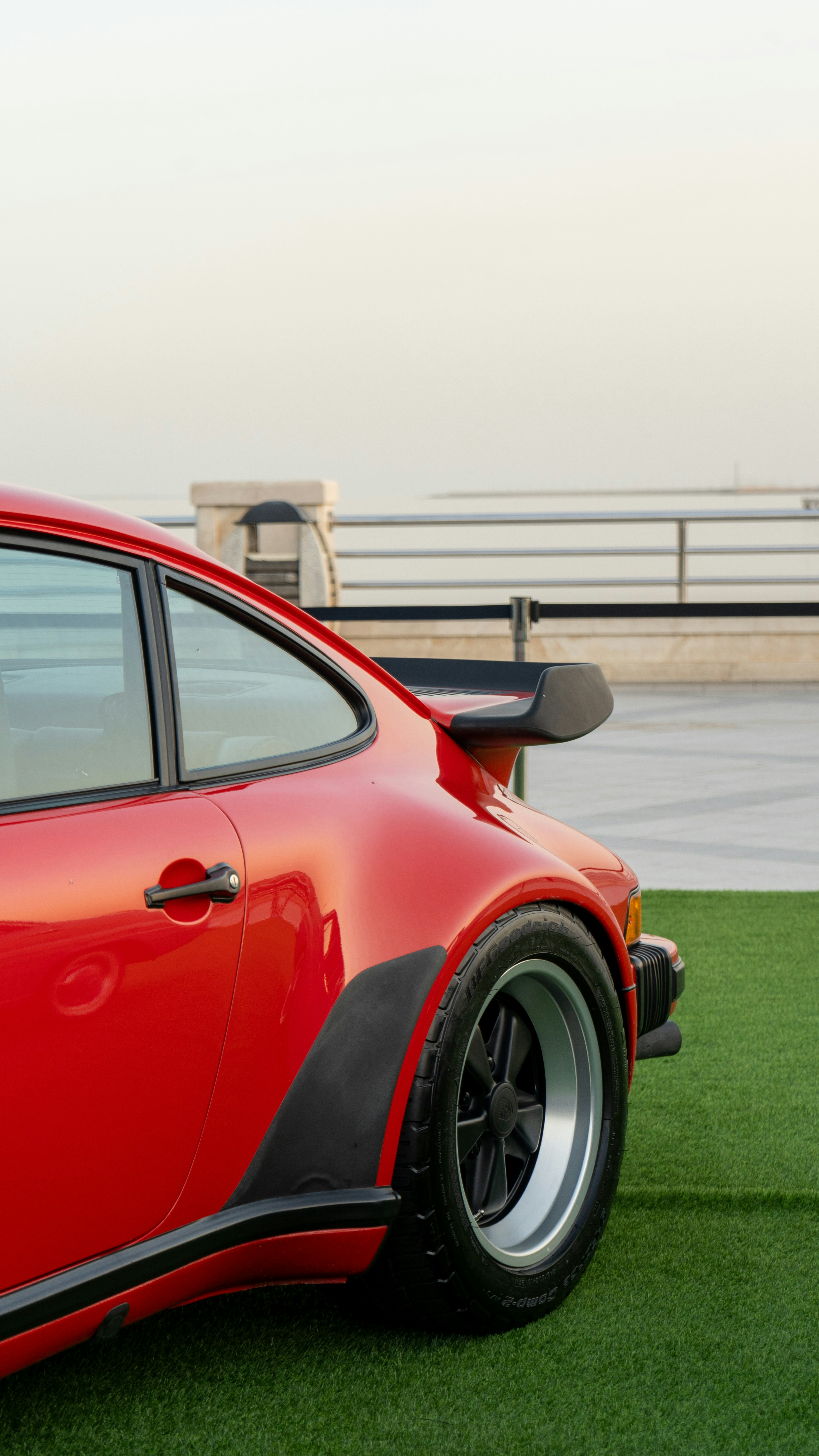 Red vintage sports car with a spoiler on grass