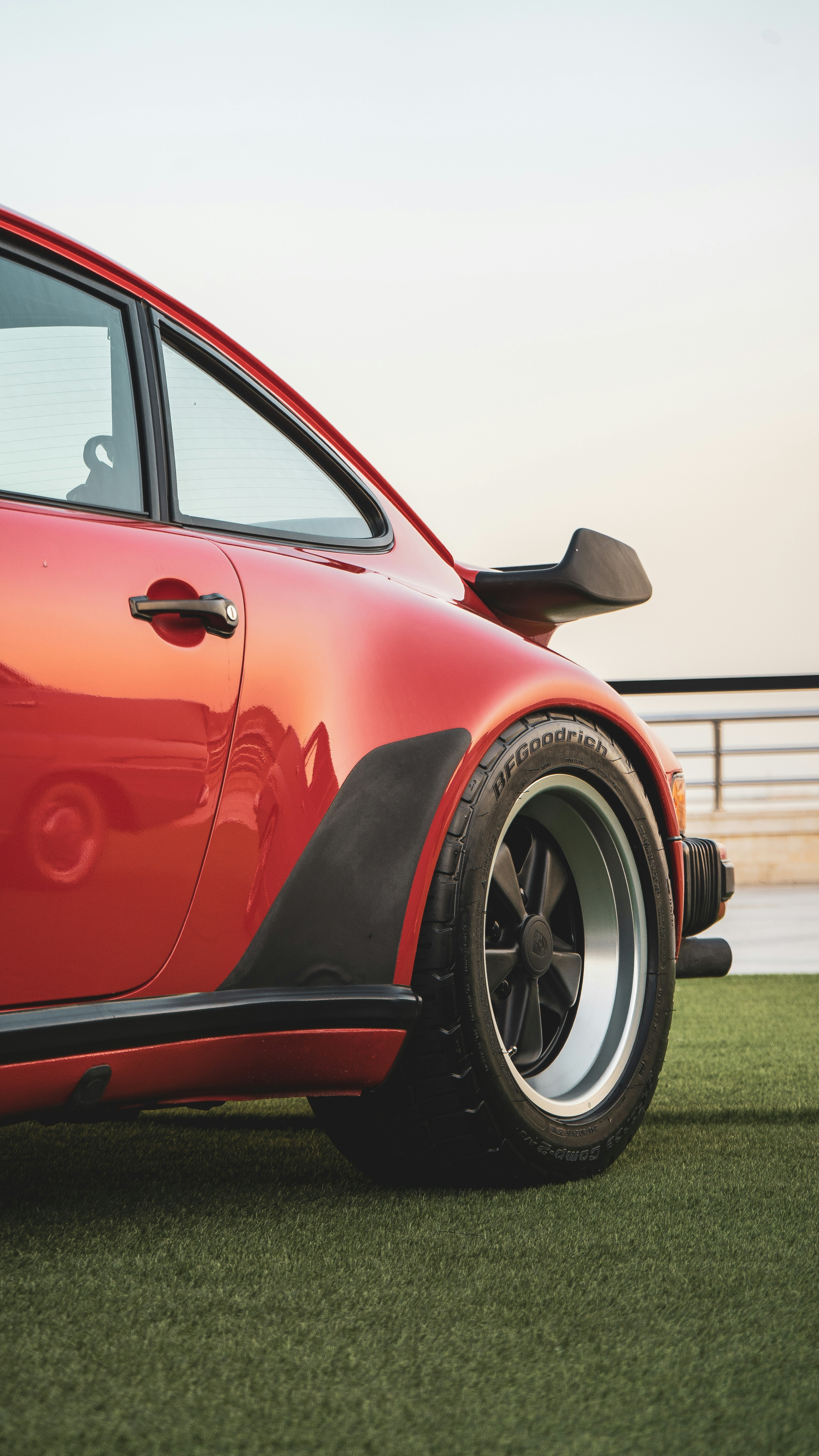 Close up of a red vintage sports car wheel.