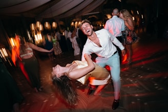 Couple dancing joyfully at a lively outdoor party