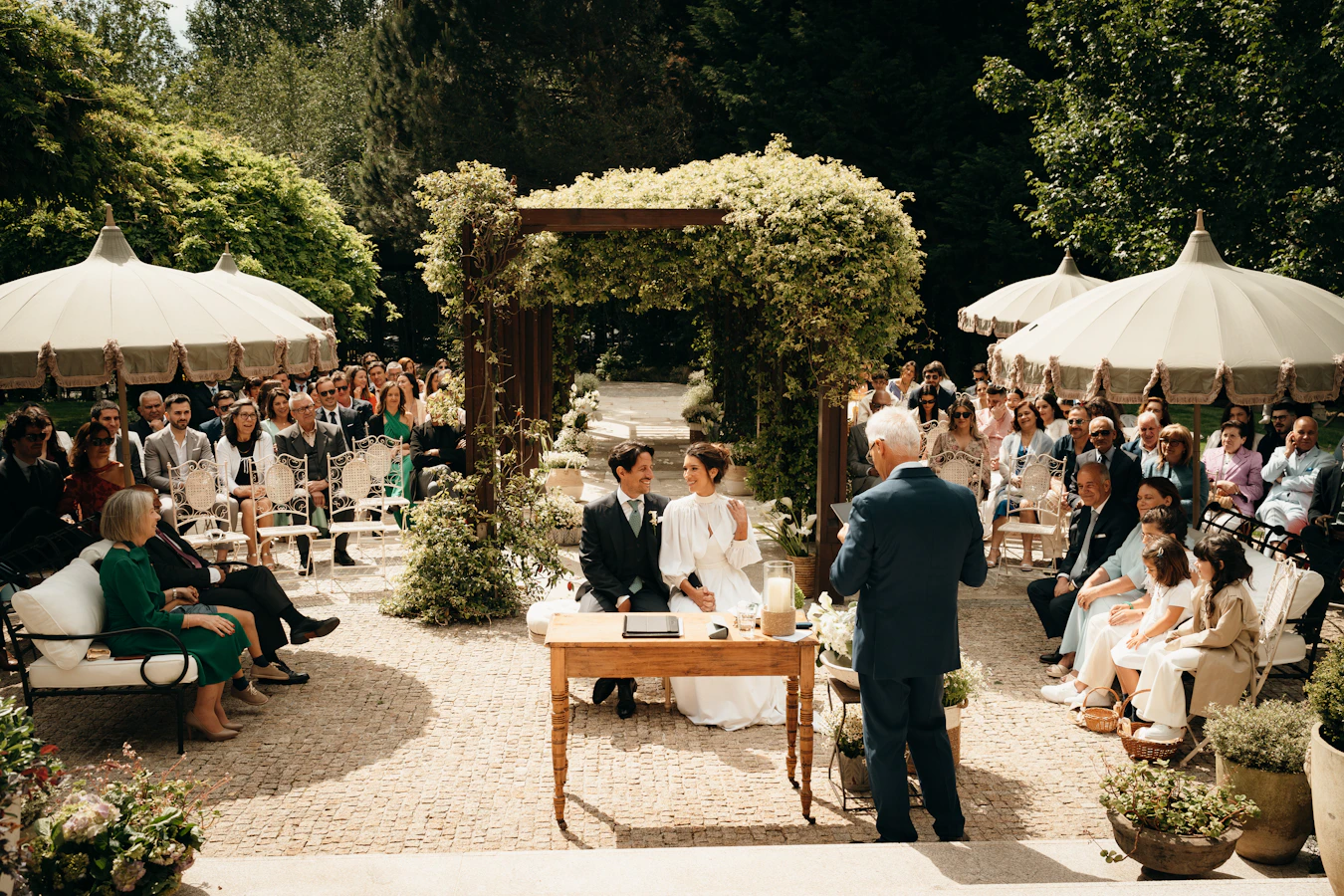 Wedding ceremony with guests seated outdoors