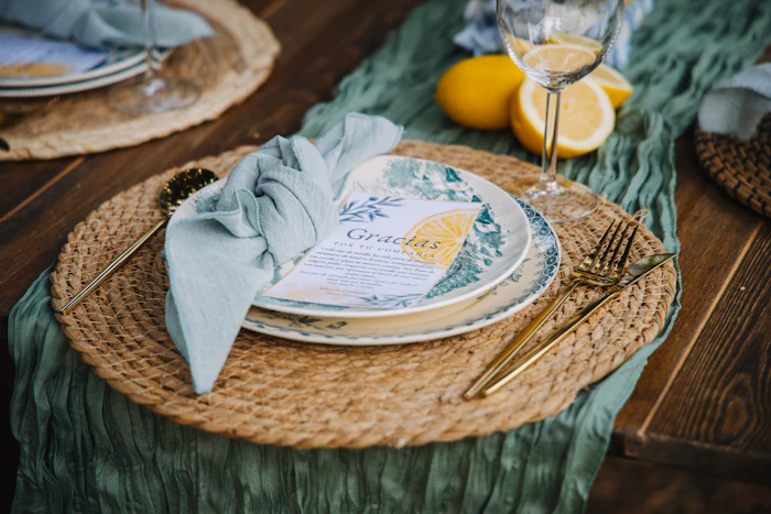 Tabletop place setting with charger, glassware, and linen